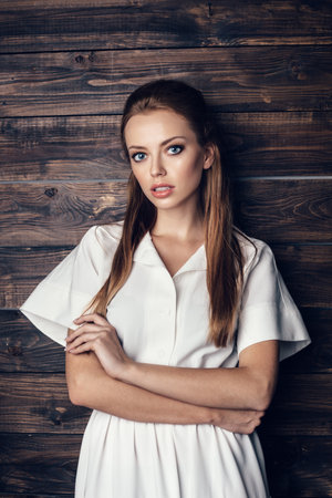 Fashion shot of young beautiful woman in white long dressの写真素材