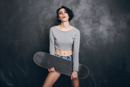 Beautiful Young woman with skateboard.の写真素材