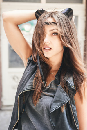 Bully sexy woman with leather cat ears. Urban scene. Outdoor lifestyle portraitの写真素材