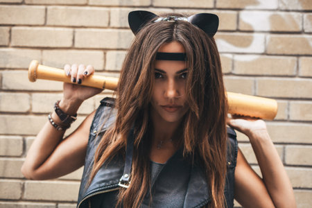 Bad sexy woman with baseball bat. Urban scene. Outdoor lifestyle portraitの写真素材