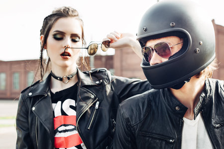 Couple in love. Bikers and vintage custom motorcycle. Outdoor lifestyle portraitの写真素材