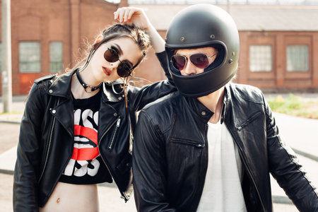 Couple in love. Bikers and vintage custom motorcycle. Outdoor lifestyle portraitの写真素材