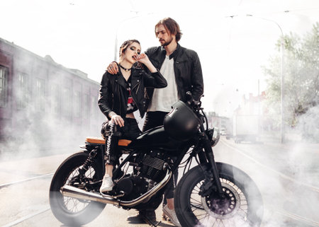 Couple in love. Bikers and vintage custom motorcycle. Outdoor lifestyle portraitの写真素材