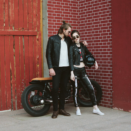 Couple in love. Bikers and vintage custom motorcycle. Outdoor lifestyle portraitの写真素材