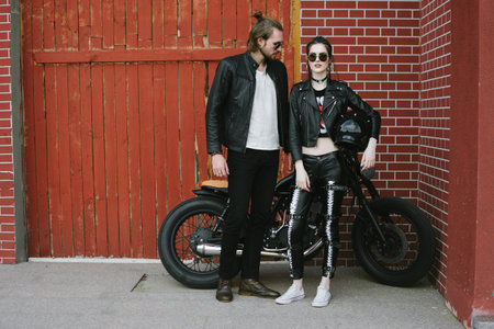 Couple in love. Bikers and vintage custom motorcycle. Outdoor lifestyle portraitの写真素材