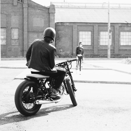 Couple in love. Bikers and vintage custom motorcycle. Outdoor lifestyle portraitの写真素材