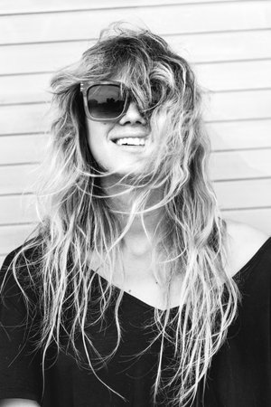 Beautiful happy woman outdoors and looking happy. Funny girl on wall background. Outdoors lifestyle...