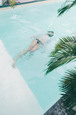 Beautiful young woman relaxing at swimming pool