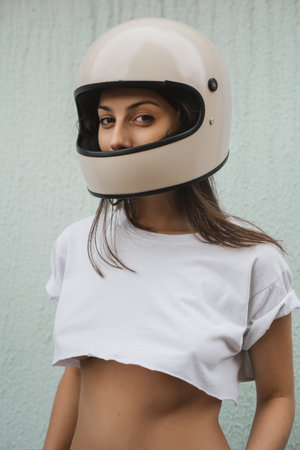 Close-up of a girl in a motorcycle helmet looking at the camera.の写真素材
