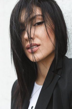 Close-up portrait of beautiful brunette woman outdoorsの写真素材