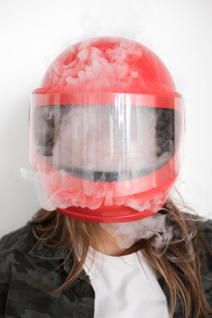 someone vapes inside the red helmet. everything is invisible. concept of losing any idea and patience, reaching emotional point, getting lost.の写真素材
