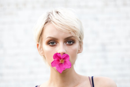 Close-up of young beautiful woman with short blond hairの写真素材