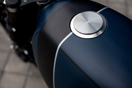 Black blue rebuilt vintage custom motorcycle cafe racer in front of wallの写真素材