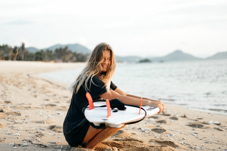 Surfer girl on beachの写真素材