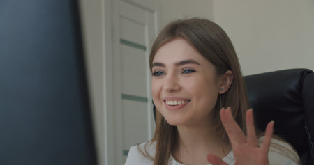 Business woman face looking at monitor in office. Close-up of girl thinking about mistakes in work. Portrait of female meeting from laptop at home. Over display camera shotの写真素材