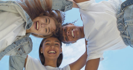 Group of friends hugging over sky on the backgroundの写真素材