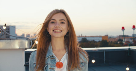 close up portrait of attractive caucasian woman smiling blonde confident pretty at a rooftop partyの写真素材
