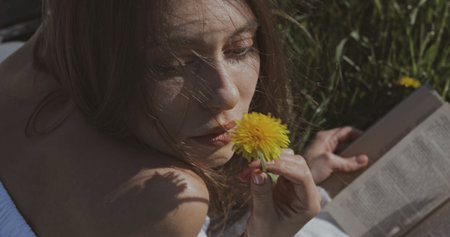 Young attractive woman with flower . Outdoor lifestyle portrait.の写真素材