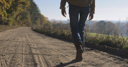 close-up of legs of Active healthy female hipster teen model hiking along forest mountain road. Foots of Caucasian girl rest outdoors . Woman tourist walking in fall park on sunny autumn dayの写真素材