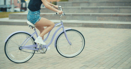 Young pretty woman riding bicycle in cityの写真素材