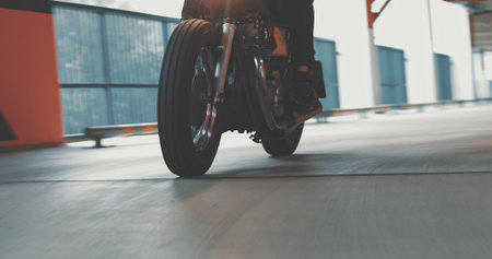 Motorbiker riding on a motorcycle in the parking lot in the city. Biker rides a vintage custom...