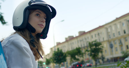 girl sits on bike and looks at cityの写真素材