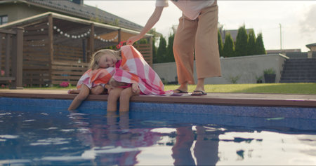 happy sisters wrapped in towelの写真素材