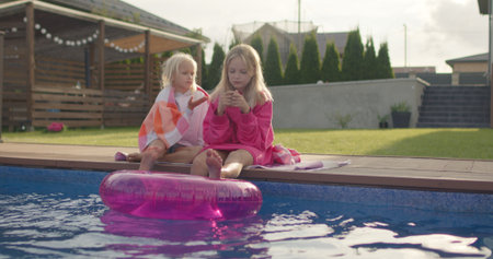 happy sisters wrapped in towel