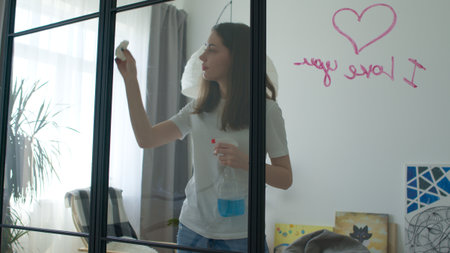 woman in room cleaning windowの写真素材