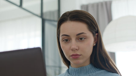 woman face looking at monitor in officeの写真素材