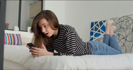 girl reading news on phoneの写真素材