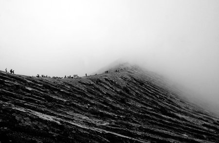 Walking trough the mist at Mount Ijen, Indonesiaの写真素材