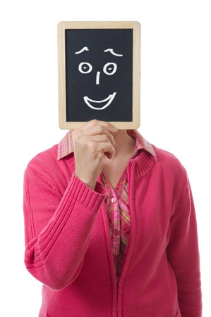 woman hiding her face behind a slateの写真素材