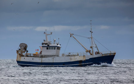 Iceland - April 28.2016 : Old commercial fishing boat sailing on the north Atlantic ocean.