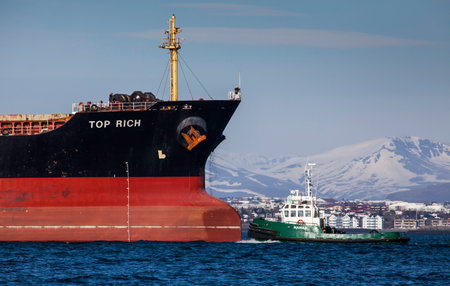 Iceland - April 26, 2016 : Cargo vessel Top Rich with tugboat in Icelandic waters.のeditorial素材