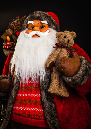 Portrait of a Santa Claus doll with black background.の写真素材