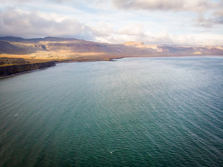 Amazing stone arch Gatklettur basalt rock on Atlantic coast of Arnarstapi in Iceland. The famous natural form arch attracts tourist to visit west of Iceland.の写真素材