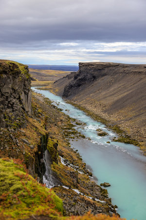 Scenic landscape view of incredible Sigoldugljufur canyon in highlands with turquoise river, Iceland. Volcanic landscape on background. Popular tourist attraction.の写真素材