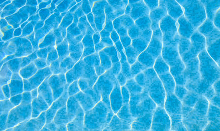 Swimming pool bottom caustics ripple and flow with waves background. Summer background. Texture of...