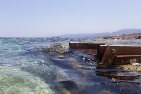 Wooden bench for relaxing in the seaの写真素材