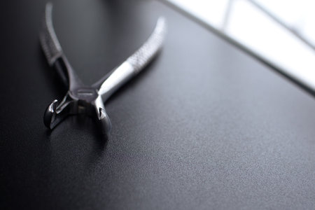 Dental pincers to remove the chewing teeth on black background.の写真素材