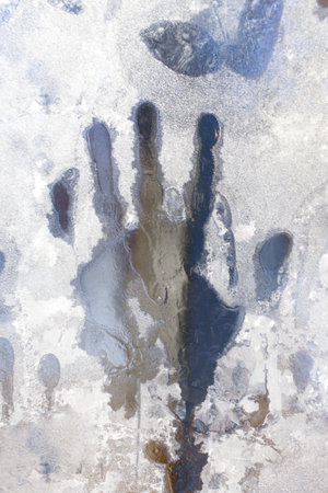 handprint on the frozen ice window. Close upの写真素材