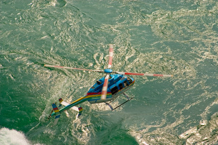 Helicopter Flying over a fast moving river.