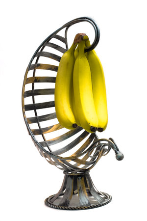 Isolated Bananas in a banana hanger on a white backgroundの写真素材