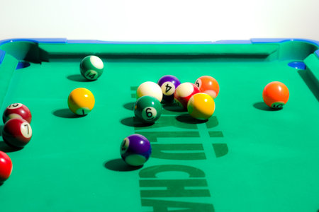 Game of pool being played on felt table