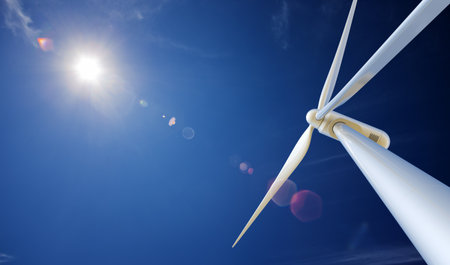 Wind Turbine from below with sun creating lens flare