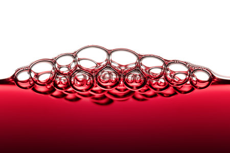 Abstract Food Art Pattern of Red Wine Bubbles photographed close-up against white backgroundの写真素材