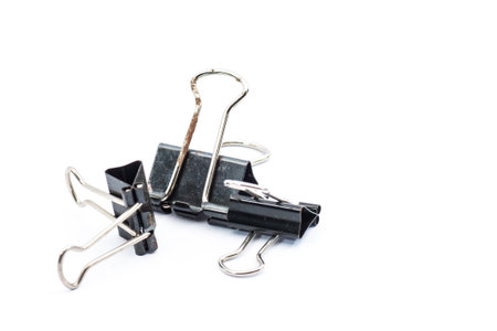Rusty binder clip with black color on isolated backgroundの写真素材