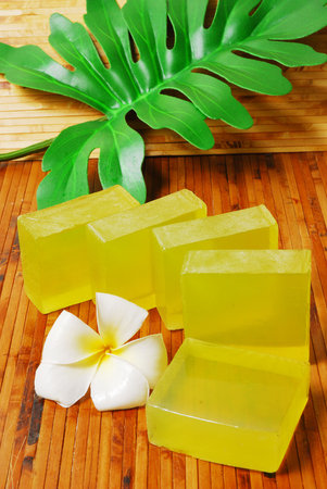 Handmade soap bars on Bamboo mat with Frangipani flowers and leaf. の写真素材
