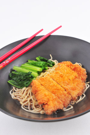 Asian pork fritter noodle soup with chopsticks closeup の写真素材